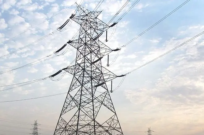 High-voltage transmission towers under a blue sky
